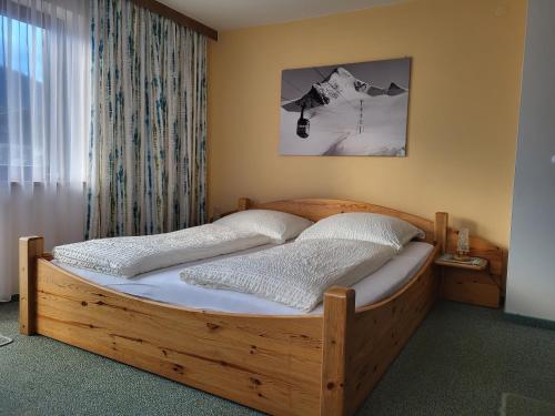 皮森多夫Landhaus Flatscher的卧室内的一张木床,卧室设有窗户