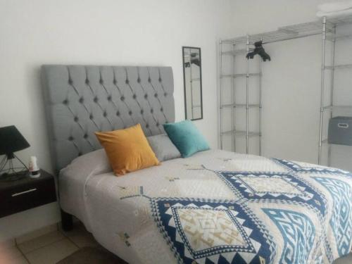 Villa de AlvarezCómoda Casa a 5 minutos del IMSS的一间卧室配有一张带蓝色和白色被子的床
