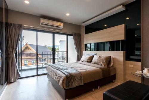 Ban Nong ChaengPremiercondo Chonburi พรีเมียร์คอนโด ชลบุรี的一间卧室设有一张大床和一个大窗户