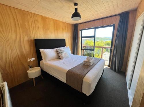 特卡波湖Wayfarers Lodge的一间卧室设有一张大床和一个窗户。