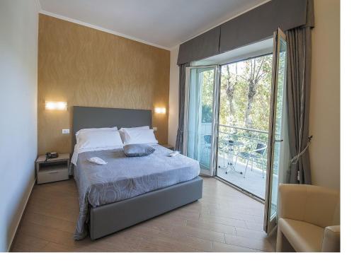 菲乌米奇诺波尔图迪克劳迪奥酒店的一间卧室设有一张床和一个滑动玻璃门