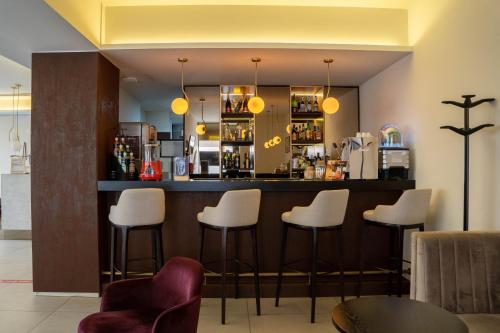 埃斯波森迪阿普利亚普拉亚酒店的酒吧餐厅,带白凳