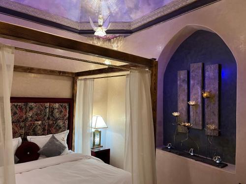马拉喀什Riad Al Ibtikar的一间卧室配有一张带紫色天花板的天蓬床