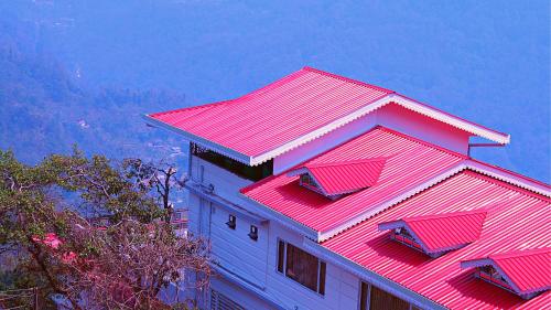 甘托克ShriGo Hotel Gangtok的一座建筑的顶部有红色的屋顶