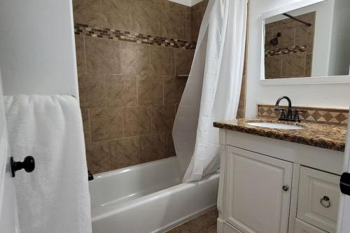 普罗沃5 bedroom house to share with your family and friends的带浴缸、水槽和淋浴的浴室