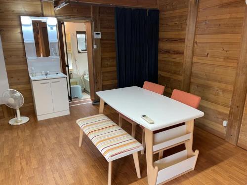 长滨市Kura "Ika" - Vacation STAY 95263v的客房设有一张桌子和两把椅子以及一间浴室。