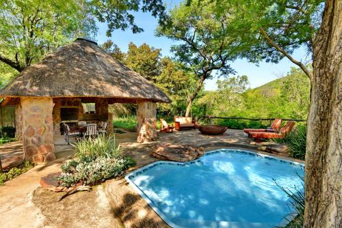 Kaingo Private Game ReserveRoyal Morubisi Founder's Lodge的凉亭和庭院内的游泳池