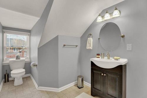 哈里斯堡Suites on Seneca - Gorgeous One Bedroom Apartment的一间带卫生间、水槽和镜子的浴室