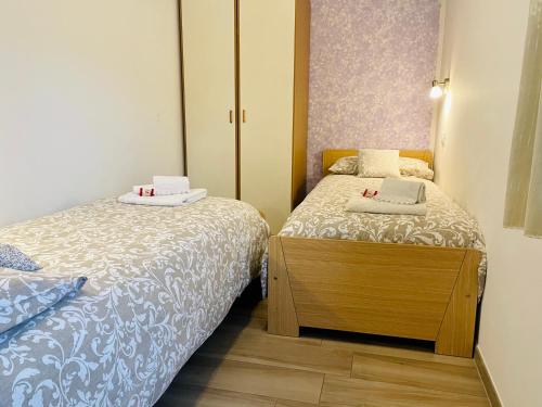 莱维科特尔梅Appartamento Verdebleu - Lago e Terme的一间带两张床和橱柜的小卧室