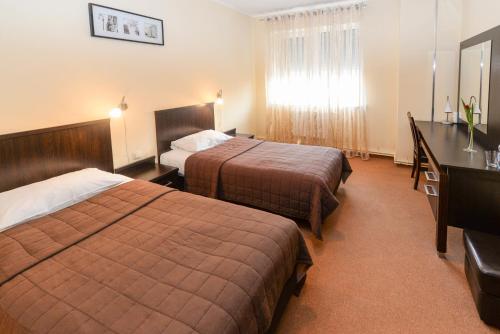 切申Hotel Liburnia的酒店客房配有两张床和一张书桌
