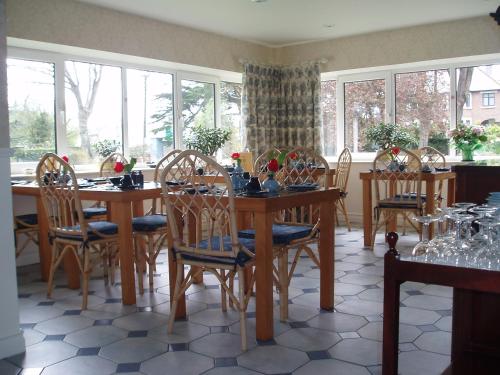 塔拉莫尔Sea Dew B&B的一间带桌椅和窗户的用餐室