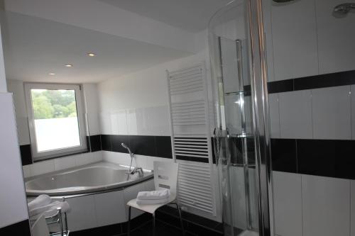 宾茨Haus Godewind的带浴缸、水槽和窗户的浴室