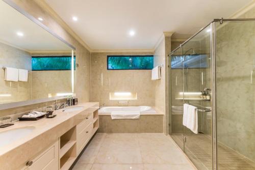 芽庄芽庄湾芬珍珠度假酒店及Spa的一间带两个盥洗盆和淋浴的浴室