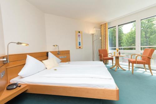 涅德托辛根Gasthaus Hotel Zum Mohren的卧室配有一张床和一张桌子及椅子