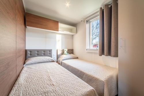 阿尔蒂多纳Centro Vacanze - Garden River的小型客房 - 带2张床和窗户
