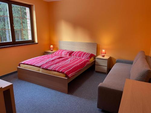 迪马诺卡多林纳Villa Aspen的一间卧室配有床、两张桌子和一张沙发