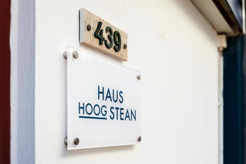 黑尔戈兰岛Haus Hoog Stean的建筑物一侧的标志,上面有特别的蒸汽