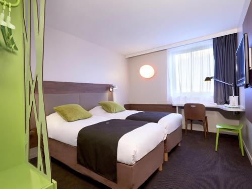 波尔多西部 - 梅里尼亚克机场钟楼酒店客房内的一张或多张床位