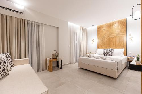 利迈纳里亚Senso Deluxe的白色卧室配有床和沙发