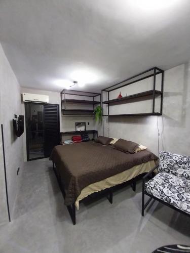圣维森特岛FLAT PALLADIUM - DE FRENTE - novo的一间卧室配有一张大床和一把椅子