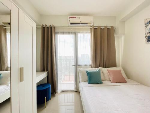 马尼拉Sakan 5-Star Quality Condotel的小房间设有床和窗户