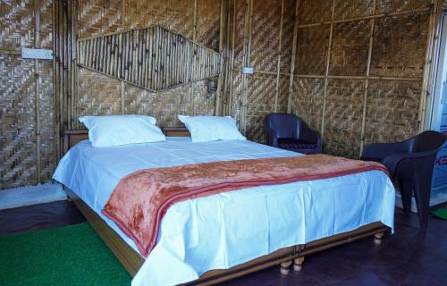 KandāghātSecret Staycation Nature Cottages的一张位于带椅子和四柱床的房间的床位