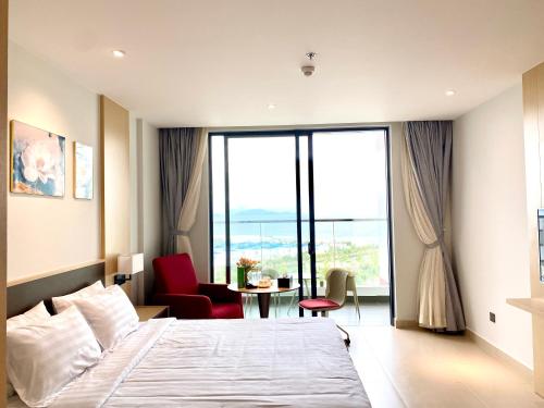 金兰市Seaview Cam Ranh Home的一间卧室配有一张床和一张桌子及椅子
