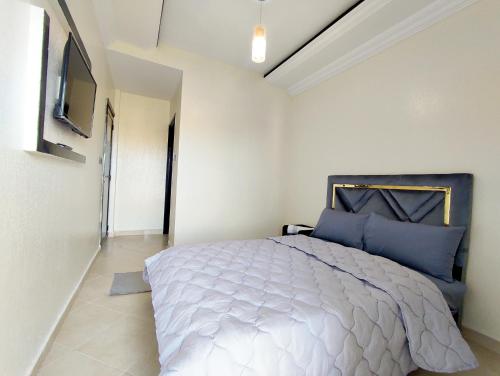 贝尼迈拉勒Hotel La coline的一间卧室配有一张带蓝色枕头的大床