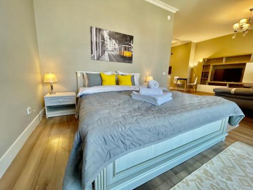 阿拉木图Шикарные апартаменты с прекрасным видом в лучшем районе的一间卧室配有一张带黄色枕头的大床