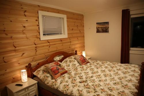 哈尔斯塔Innsletta holiday home的一间卧室配有一张木墙床