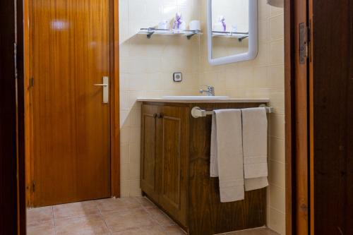 普奇塞达Hostal L'Estació的一间带水槽和镜子的浴室