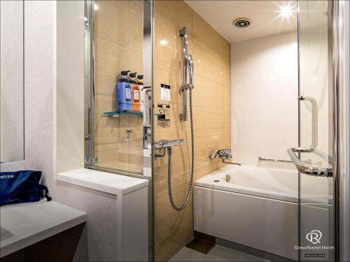 熊本Daiwa Roynet Hotel Kumamoto的带淋浴、盥洗盆和浴缸的浴室