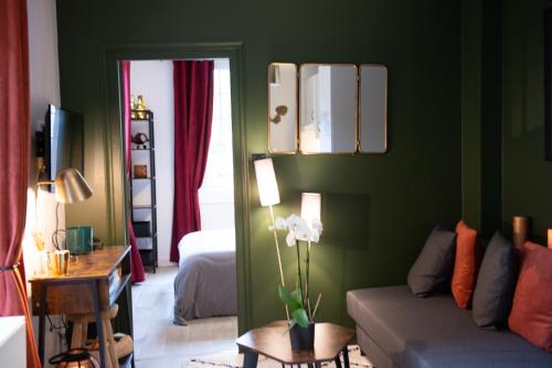 莱桑德利Les Gites By Carpe Diem的客厅设有绿色的墙壁和沙发