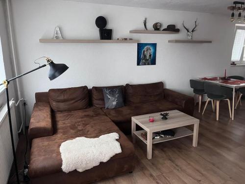 ChyšeChata s panoramatickou saunou的客厅配有棕色沙发和桌子