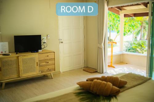 库德岛库德岛暹罗海滩度假村的客房设有带一张床和电视的卧室。