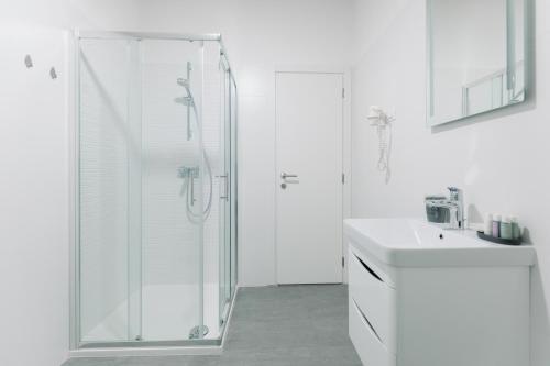 梅杜林Boutique Suites Joyce Medulin with free parking的带淋浴和盥洗盆的白色浴室