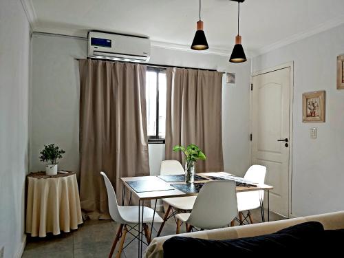 门多萨Luminoso departamento en zona residencial的客厅配有桌子和白色椅子