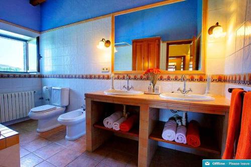巴利-略夫雷加Mas dels Avis Tipica Masia Catalana的浴室设有2个水槽、卫生间和镜子。