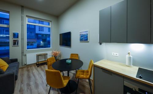 雷克雅未克Center apartments - Hekla的厨房以及带桌椅的起居室。