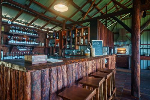 PortsmouthManicou River Resort的酒吧配有木桌和木椅