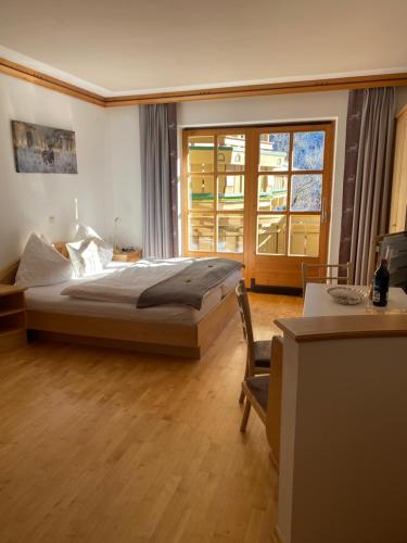 OberkrimmlLandhaus Rosengartl Krimml的一间卧室设有一张床和一个大窗户
