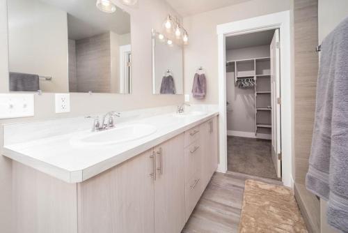 比林斯Delightful, new townhome downtown的白色的浴室设有水槽和镜子
