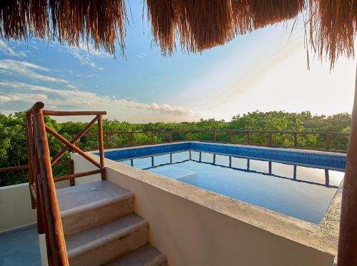 图卢姆Naajal Tulum Boutique Hotel - Magic & Jungle的房屋阳台上的游泳池