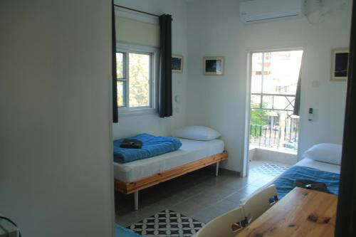 提比里亚大卫旅舍的客房设有床、桌子和镜子