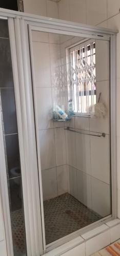 恩潘盖尼Saginix Guesthouse的浴室内带镜子的淋浴