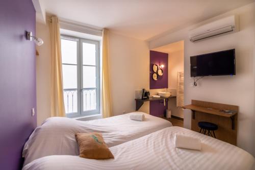 萨尔拉拉卡内达Sarlatitude, Studios & Chambres的酒店客房设有两张床和窗户。