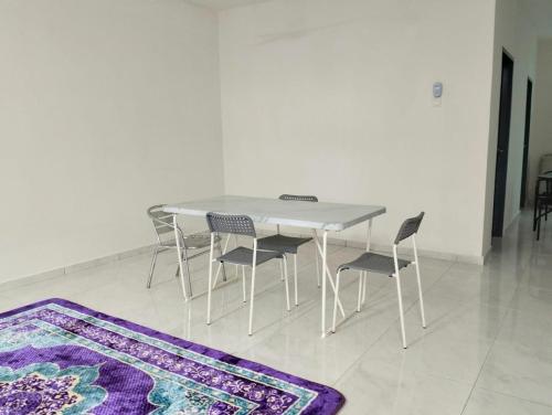日得拉Mahzan Homestay的白色的桌椅和紫色的地毯