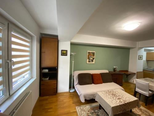 斯科普里apartment24的一间卧室配有一张床、一张书桌和一个窗户。