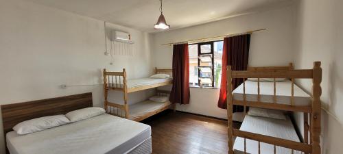 布卢梅瑙Hostel Rota do Vale的客房设有两张双层床和一扇窗户。