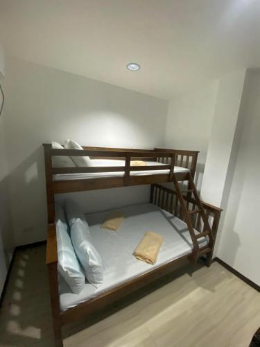 PalomponMa Lourdes Inn- Washington Street的客房内的双层床配有白色床单和枕头